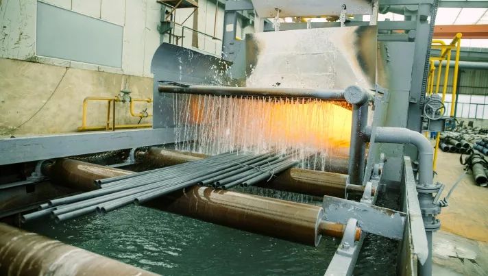 Solution annealing heat treatment line for seamless steel pipes